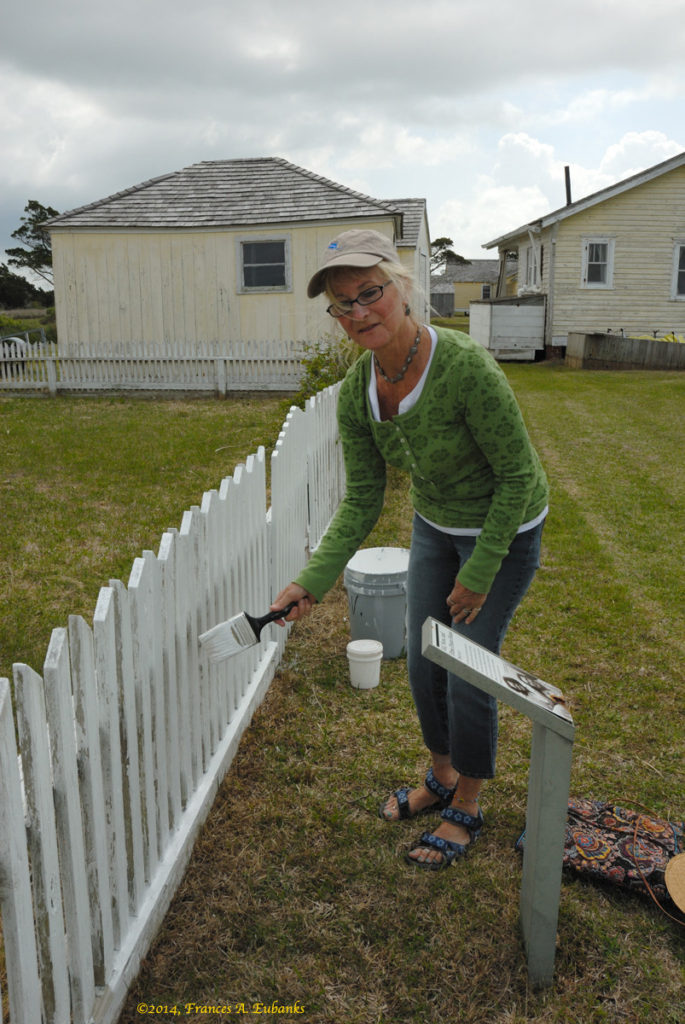 Volunteer Paints Fence in Preparation for Homecoming 2014